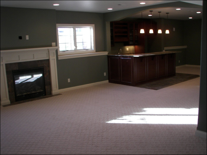 after basement remodel with fireplace