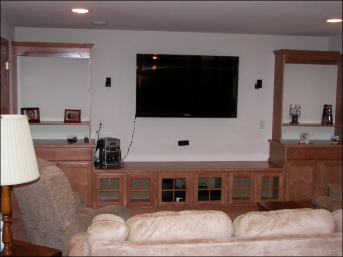 Basement living room with custom lighting & cabinets