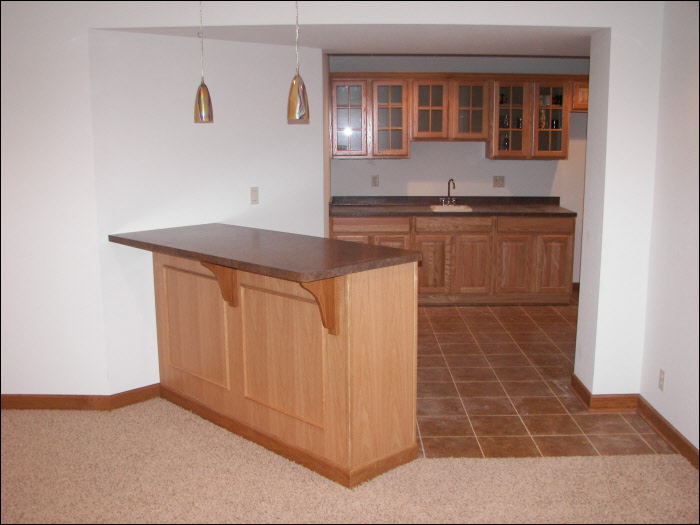 Finished wet bar construction with custom cabinetry