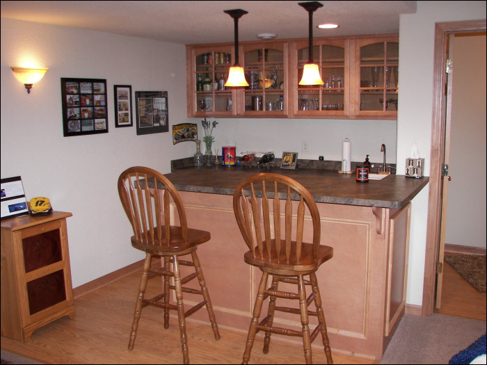 Custom wet bar with maple wood basement construction