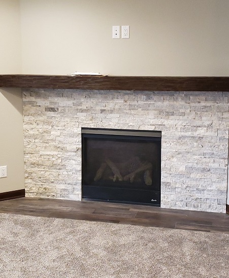 Basement fireplace remodel in Waukesha home