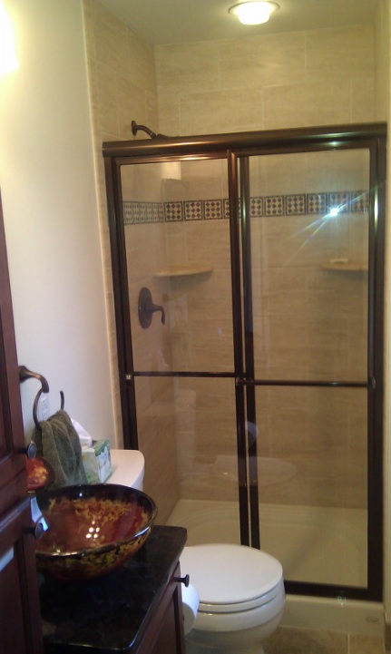 Modern half bath remodel with floating vanity and bold wallpaper